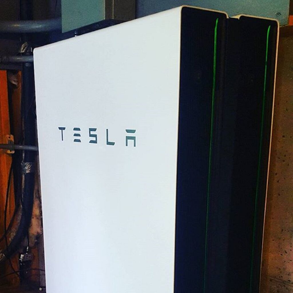 Tesla Powerwall home battery mounted indoors